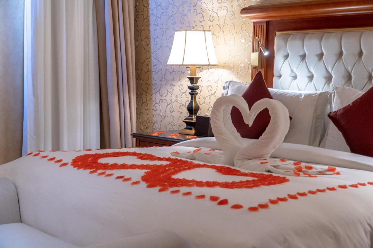 Al Aziziyah Boutique Hotel By The Torch Al Rayyan Exterior photo A bed decorated for Valentine's Day